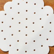 White perforated scalloped-edge round steamer liner paper